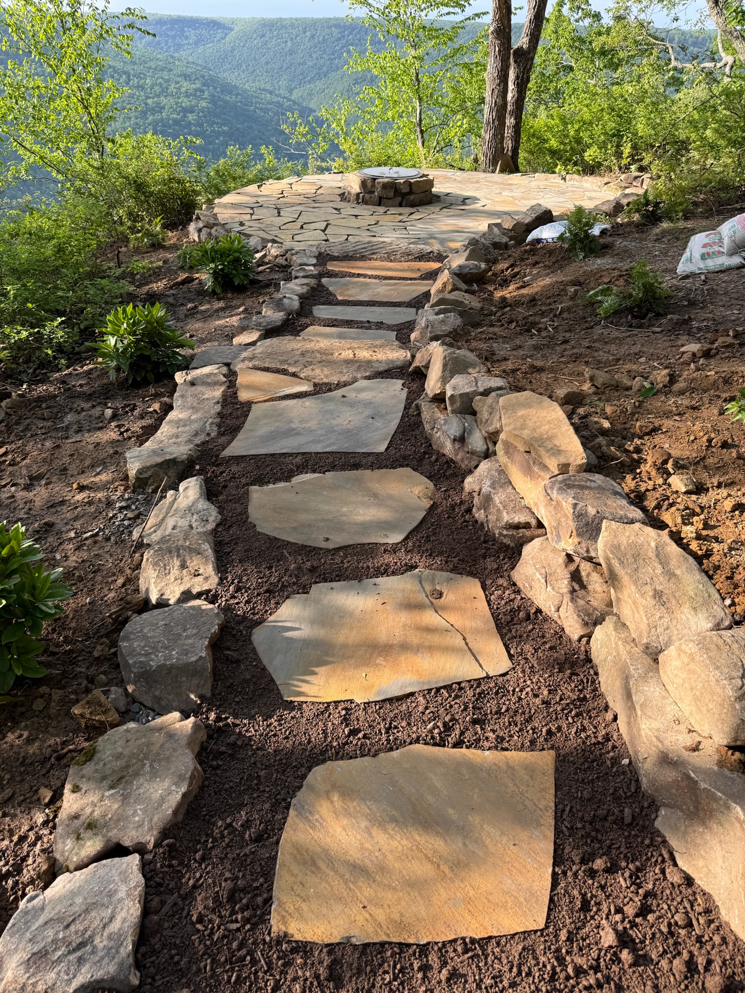 Backyard design-build with patio and fire pit in Ooltewah