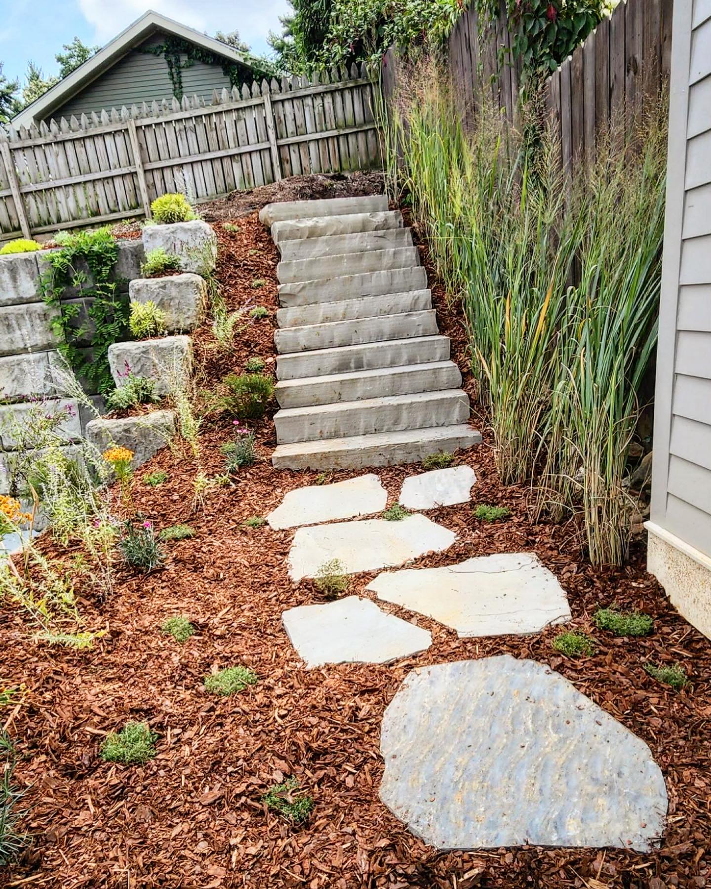 Stone pathway with stairs beside a retaining wall
