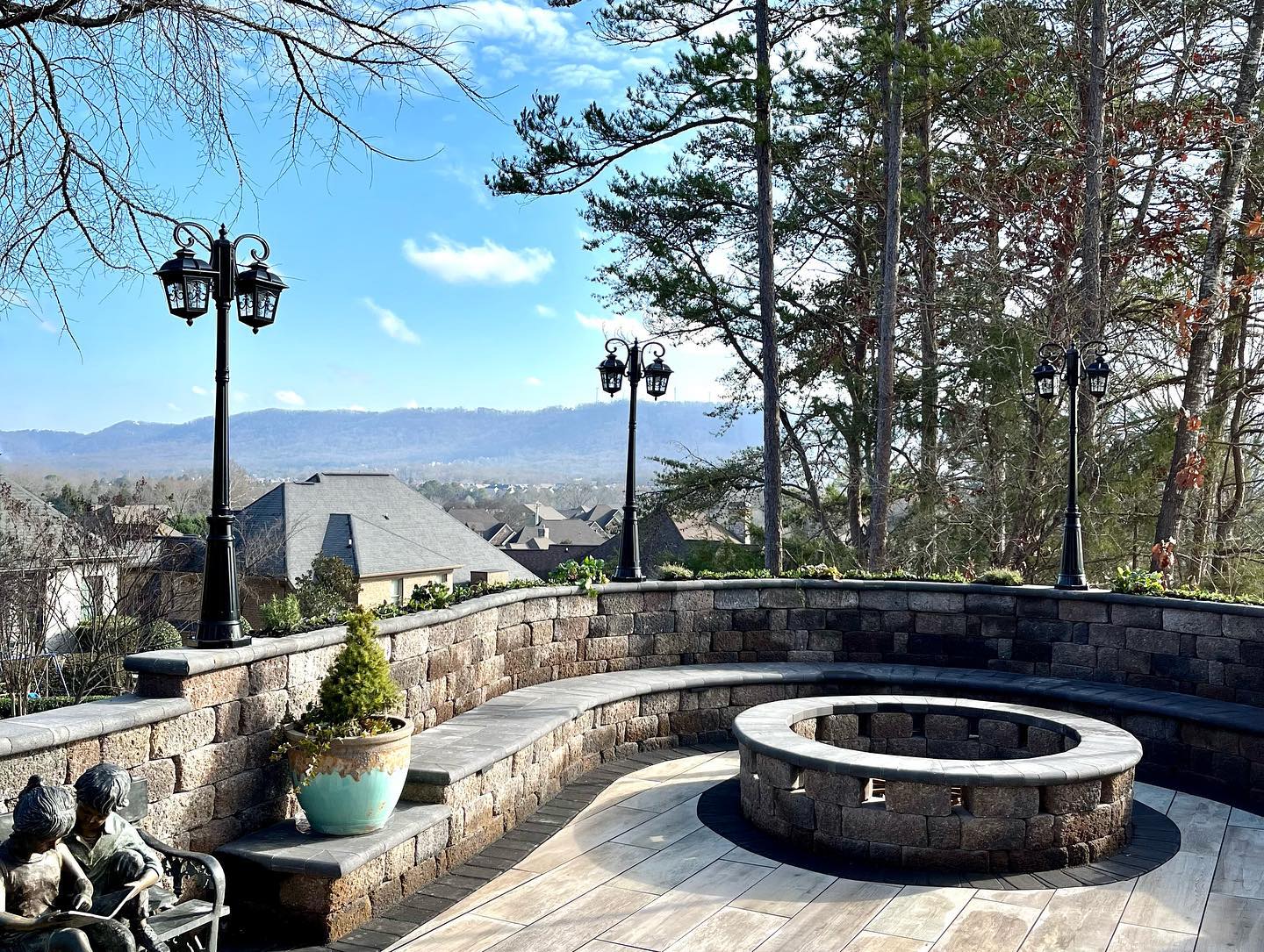 Patio with fire pit, stone wall and bench