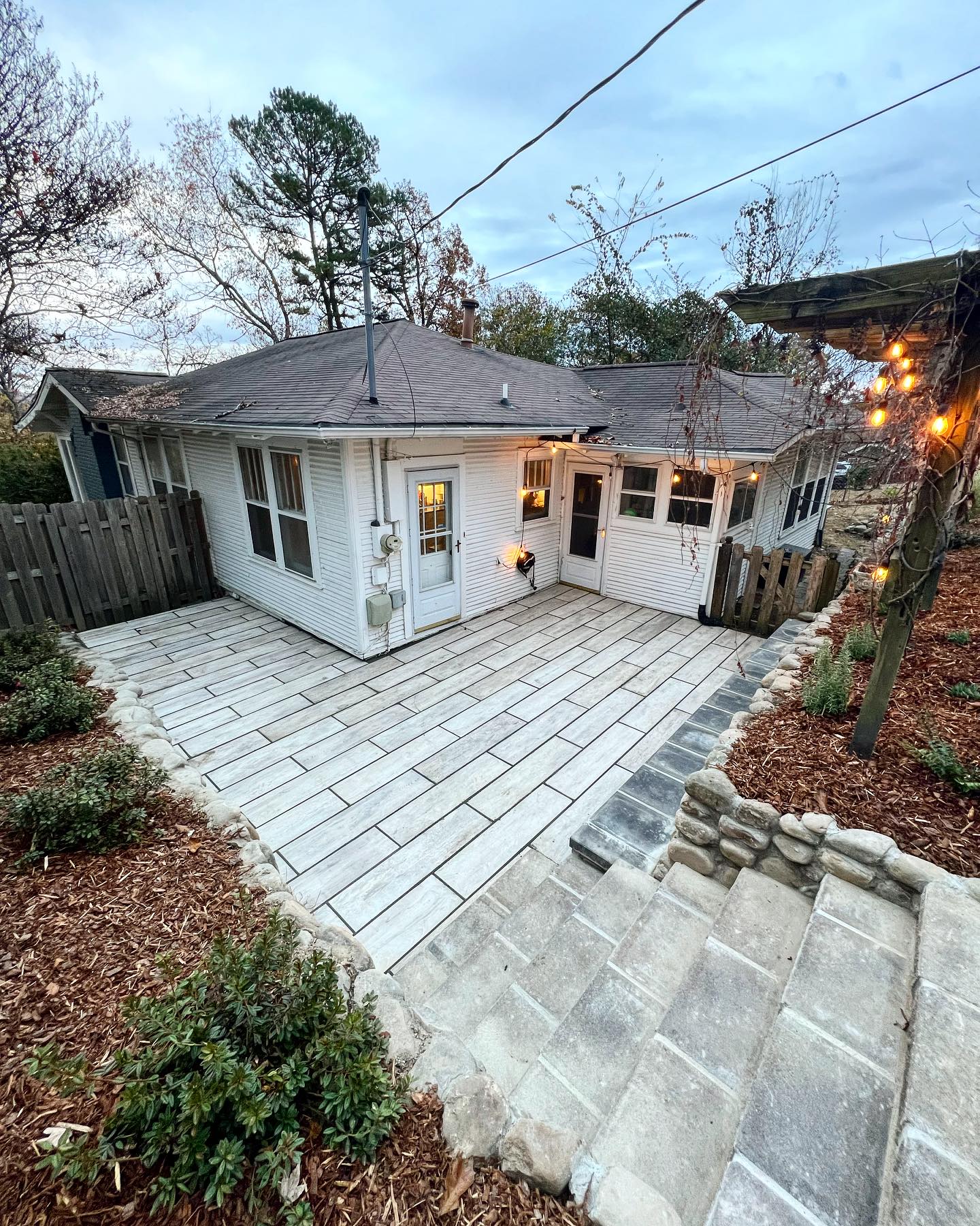 Tile patio with stairs and accent lighting